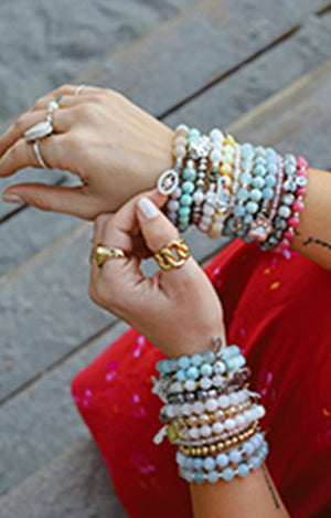 Model is wearing T.Jazelle beaded stack bracelets