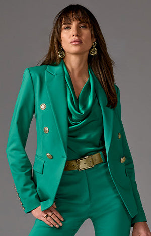 models wearing green blazer with matching tank and trousers