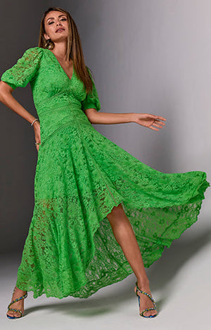 Model is wearing maxi green lace dress with green heels